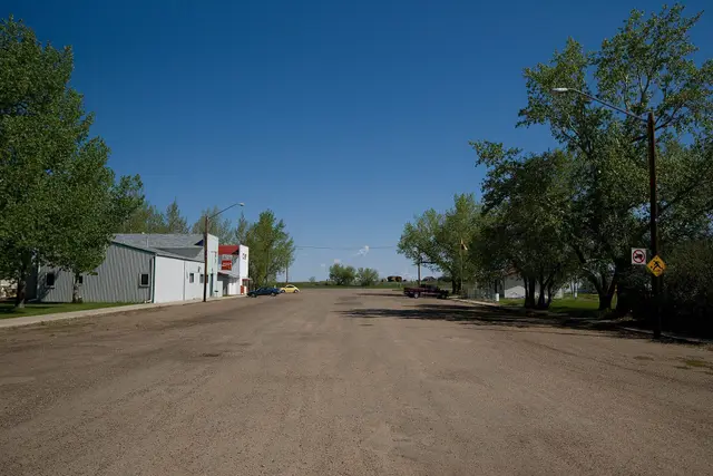 Gravel main street with shops and trees